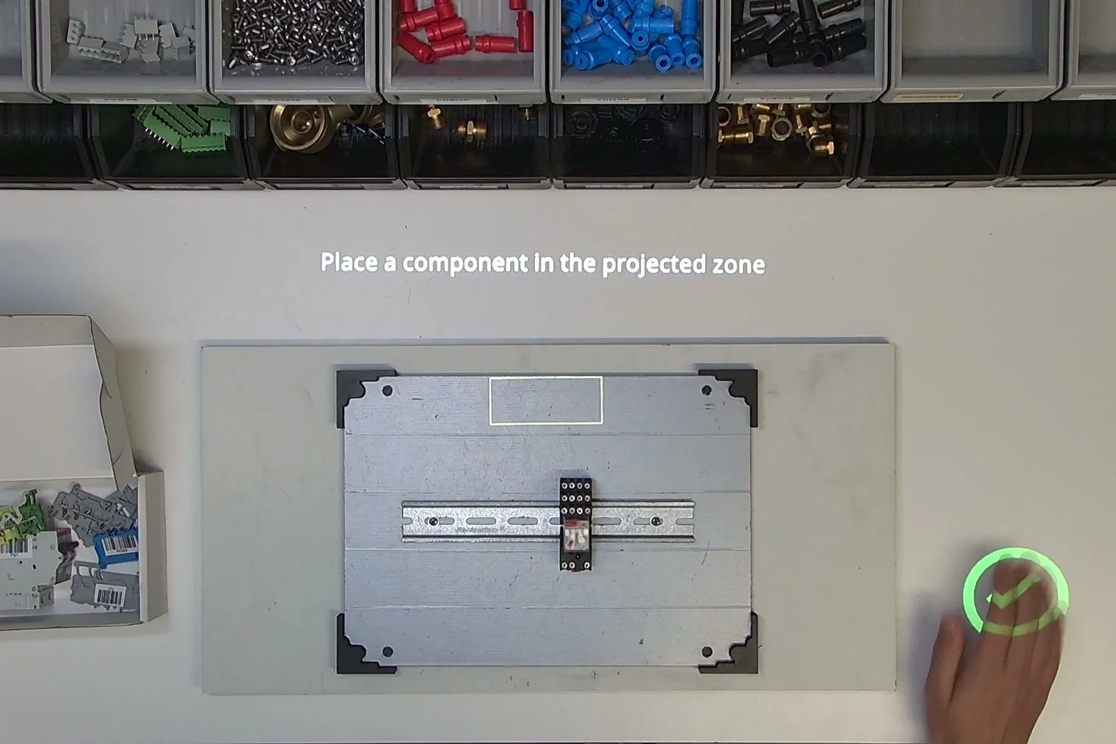 A projected zone marks where the component goes, and a check mark confirms the step